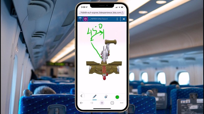 A imagem apresenta a foto sobreposta; em primeiro plano, há um celular com a Plataforma 3DEXPERIENCE aberta, rodando um projeto e com a pessoa escrevendo por cima; em segundo plano, há o interior de um avião, com diversos bancos.